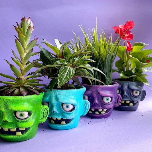 Group of colorful monster flower pots – handmade papier-mâché planters with faces and funny teeth