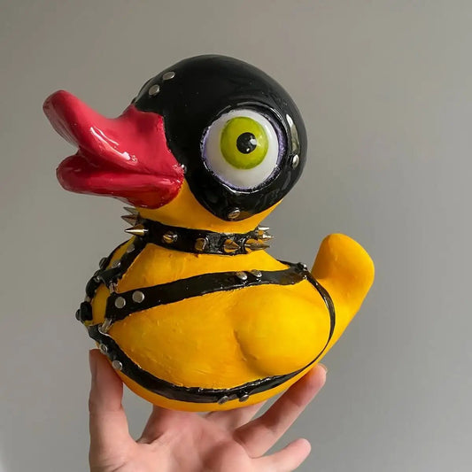 Handmade BDSM duck figurine with mask and harness – front view in hand