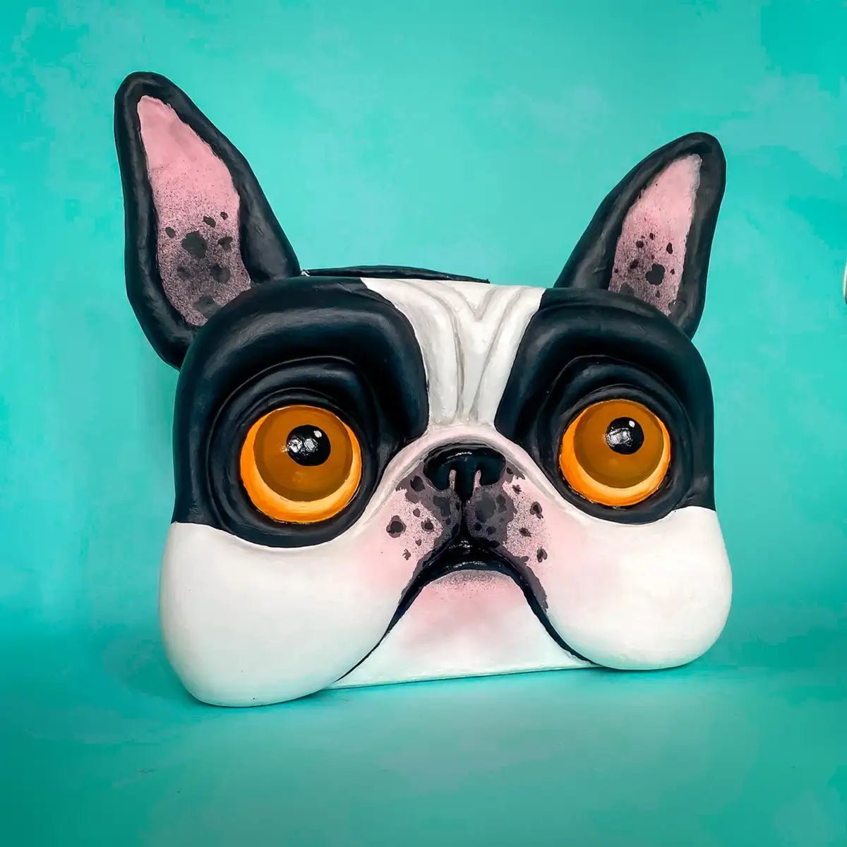 Front view of papier-mâché bulldog suitcase with upright ears