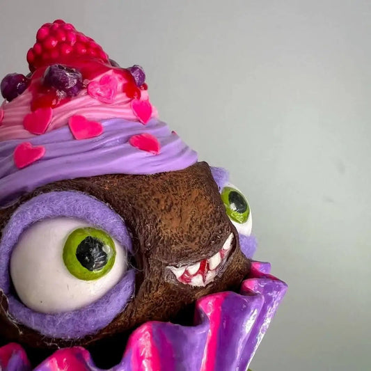 Close-up of expressive eyes and raspberry frosting on cupcake