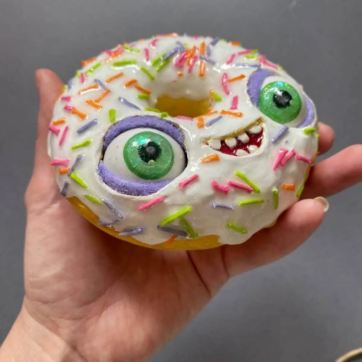 Side view of donut sculpture with expressive green eyes