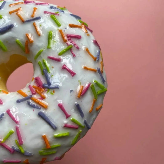 Close-up of icing with colorful sprinkles on handmade donut