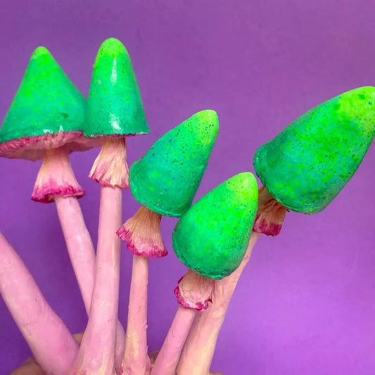 Close-up of mushroom caps showing green texture and sculpted detail