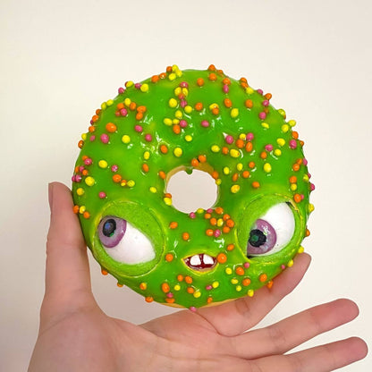 Bright green papier-mâché donut character with moving eyes, candy sprinkles and teeth – handmade fake food craft