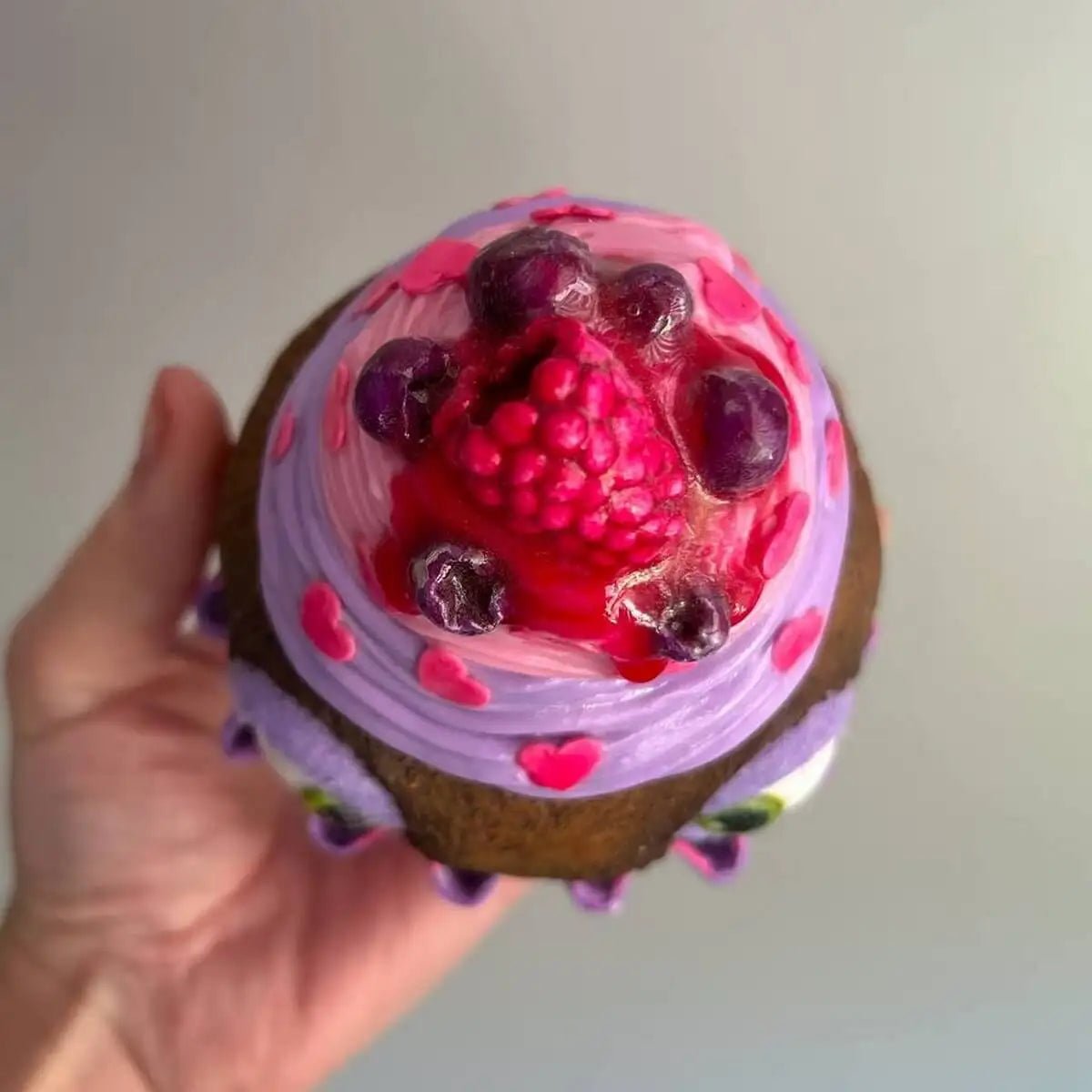 Top-down view of cupcake – raspberries and glaze in detail