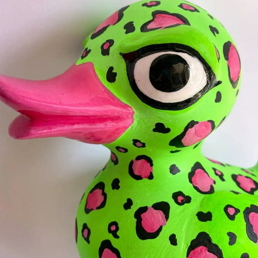 Close-up of eye and beak on leopard-print papier-mâché duck