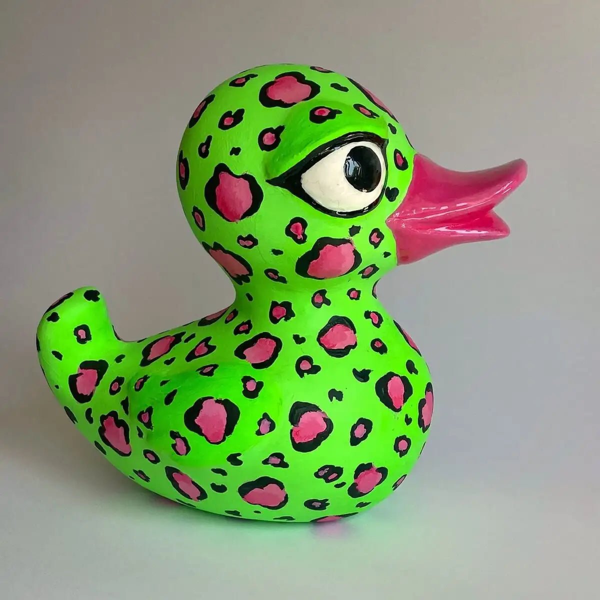 Side view of duck figurine on white background