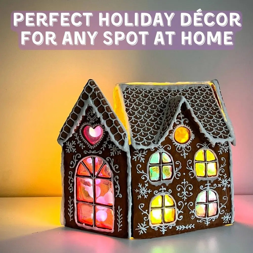 Gingerbread house night light displayed as holiday décor on a shelf with glowing stained-glass windows
