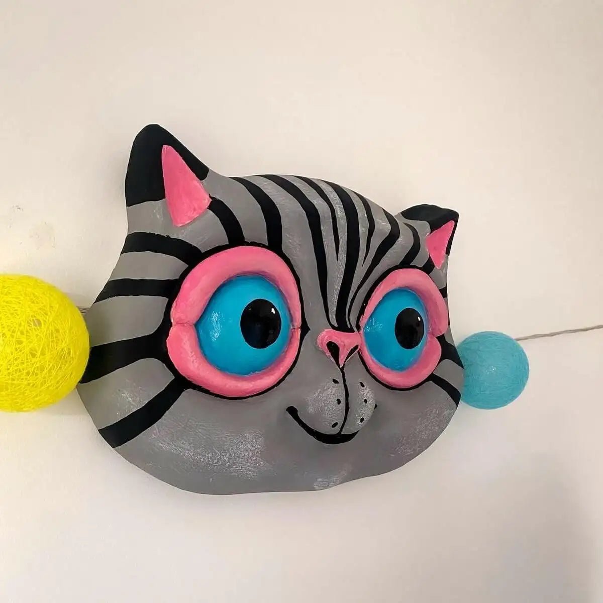 Side view of gray cat wall sculpture with visible depth and ears