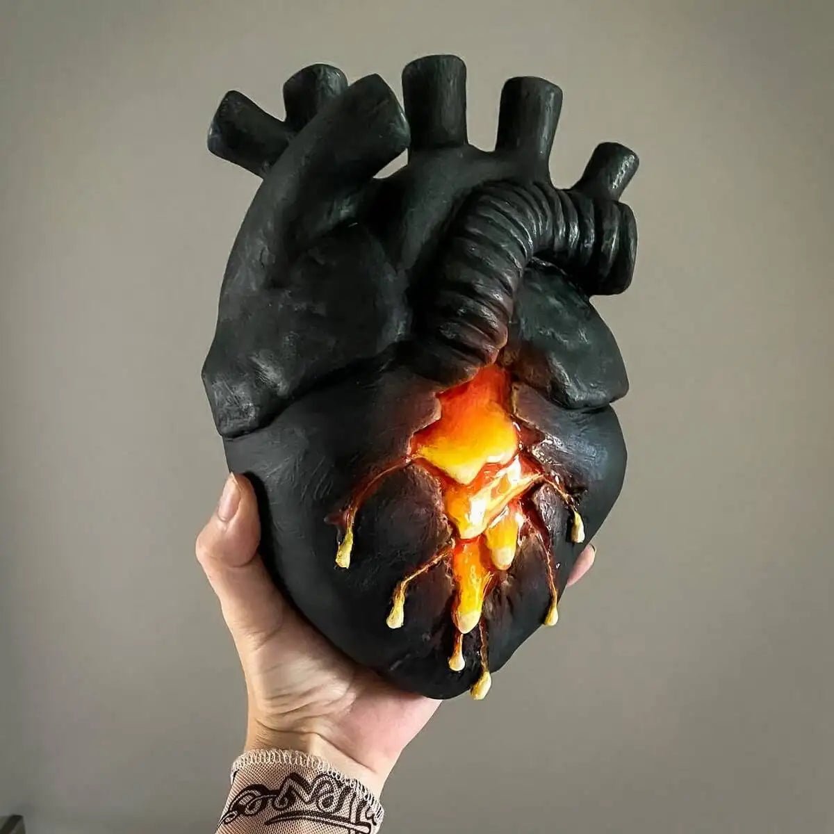 Neutral front shot of lava heart vase held by hand