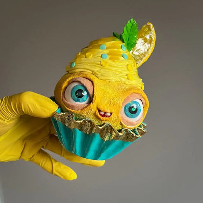 Lemon cupcake sculpture in hand – fun yellow decor with moving eyes