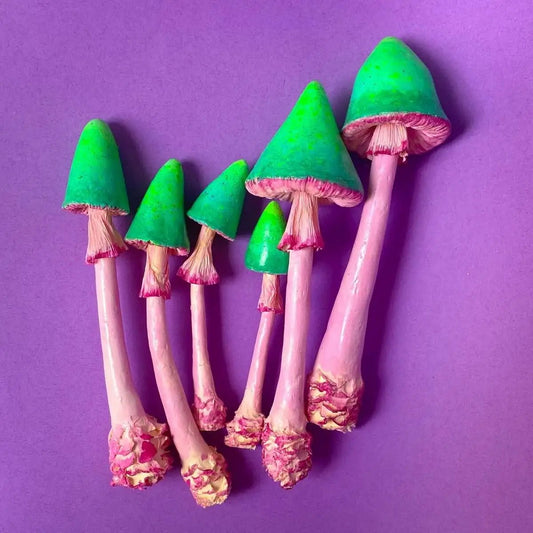 Full set of 6 papier-mâché mushrooms in three sizes on purple background
