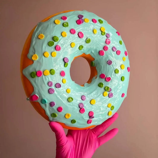 Handmade blue papier-mâché donut held in hand – colorful wall sculpture