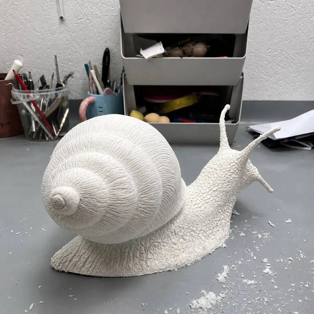 Handmade papier-mâché snail sculpture before painting and final decoration