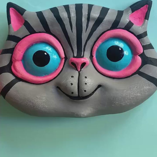 Video showing front and reverse side of cat wall sculpture