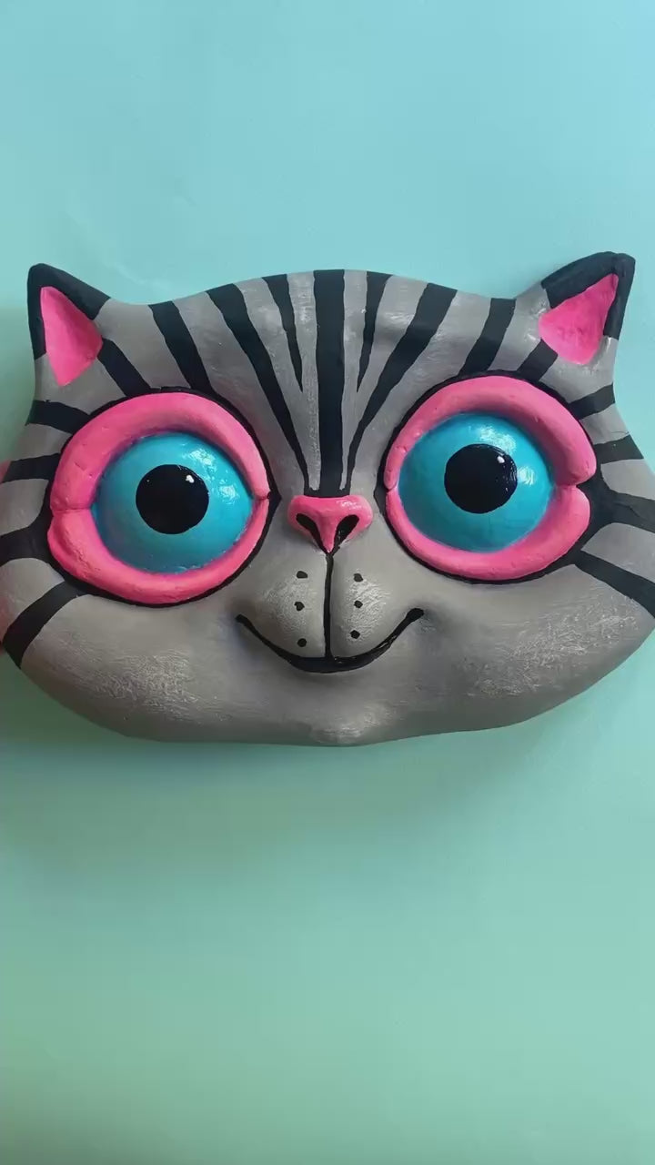 Video showing front and reverse side of cat wall sculpture
