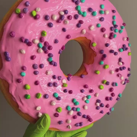 360° video of pink papier-mâché donut – close-up on glaze and sprinkles