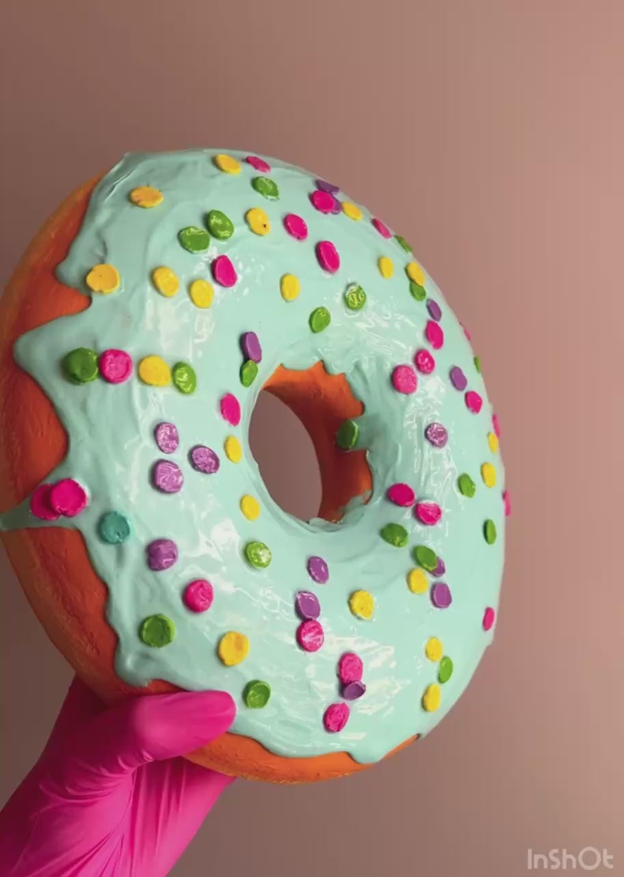 Close-up video of blue papier-mâché donut with sprinkles and texture