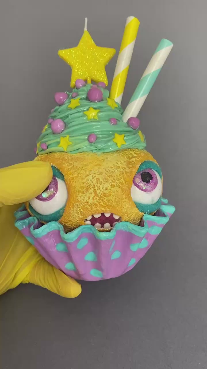 Video showing cupcake with moving eyes and real candle in multiple angles