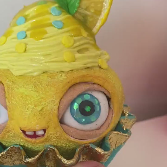 Video of lemon cupcake in hands – showing texture and eyes