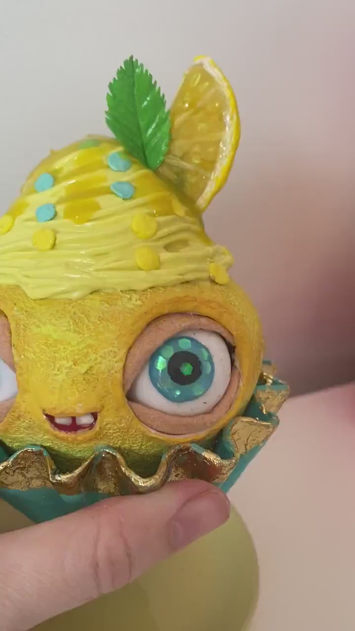 Video of lemon cupcake in hands – showing texture and eyes