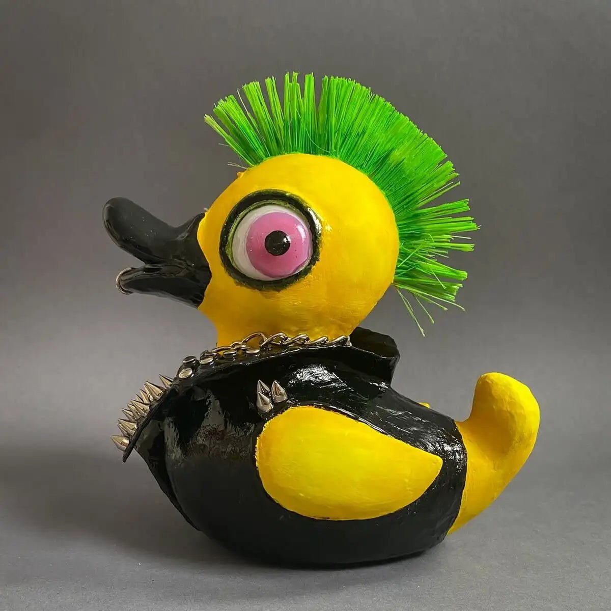 Left profile of punk duck with yellow body and black leather jacket