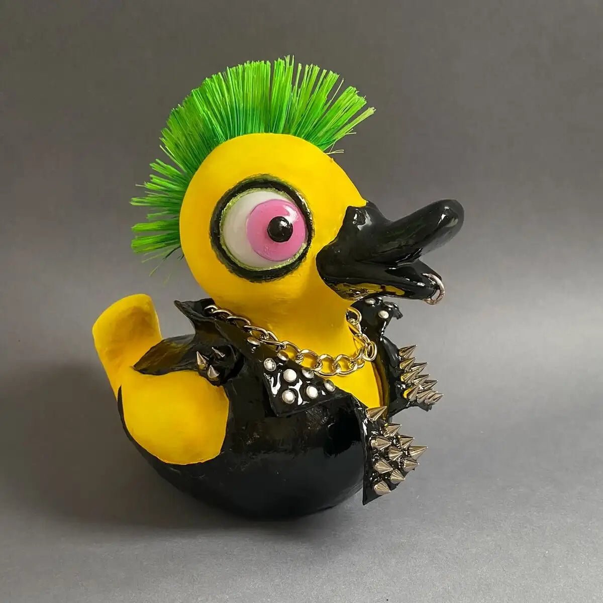 Papier-mâché punk duck – side view showing mohawk and chain